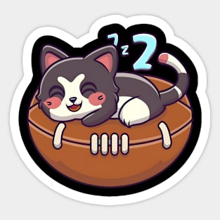 Cute cat napping on a American football Sticker